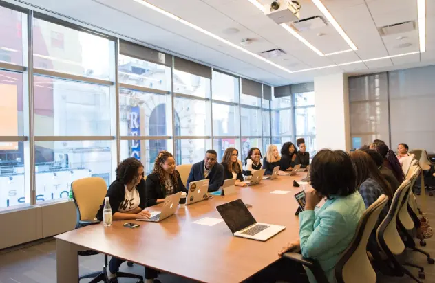 Employees in a conference room engaged in a discussion about the impact and integration of AI-powered enterprise search software in modern business operations